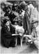 Japan: 'Faithful dog Hachiko' being fed by a Japanese couple at Shibuya station, Tokyo, in a photograph taken 15 April, 1934, a year before Hachiko's death
